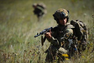 Soldiers aged 18 to 24 practice military skills on a training ground near Kharkiv, Ukraine